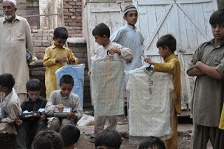 Boys receive their new clothes.